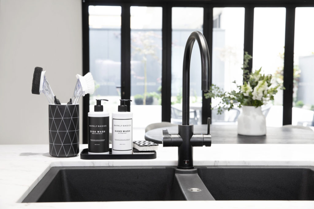 Designer cleaning products by Barkly Basics displayed on kitchen bench by sink