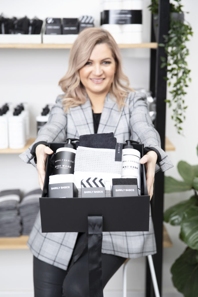 Barkly Basics founder Dr Natasha Malkov holding a gift box of products