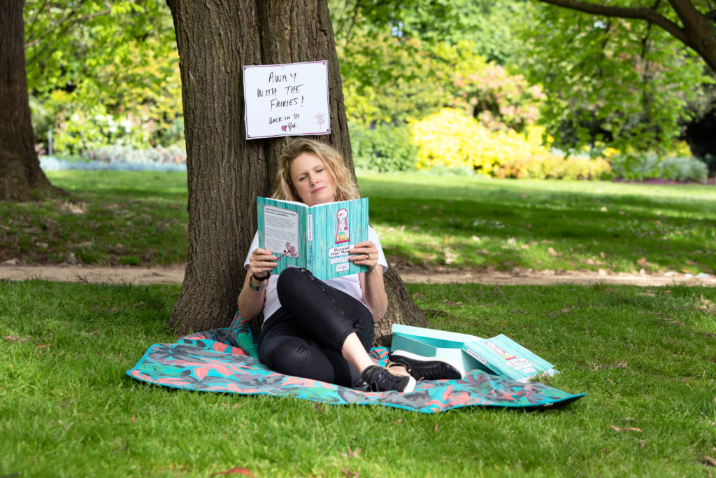 Lady reading a book under a tree