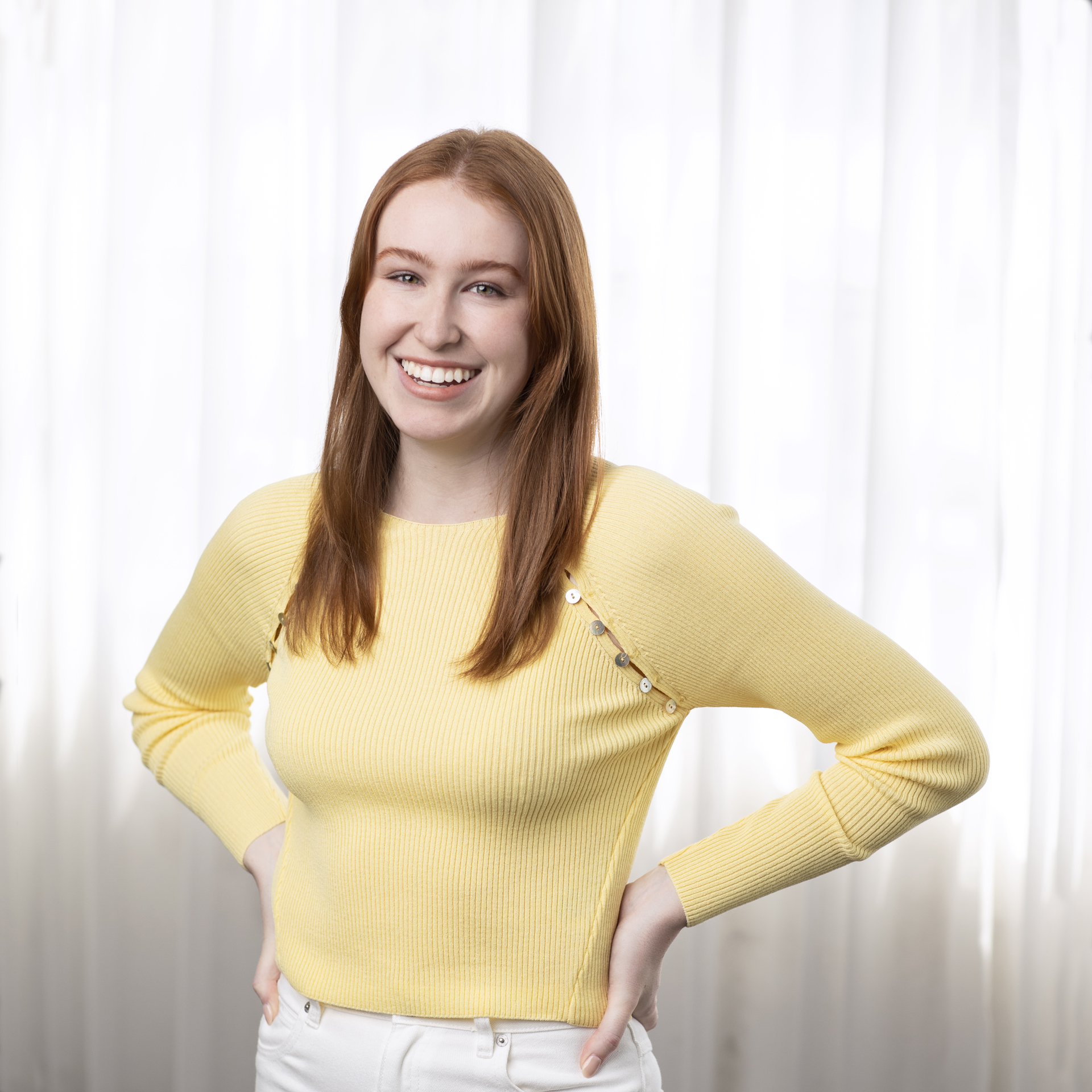 Personal branding portrait of a red headed lady dressed in yellow