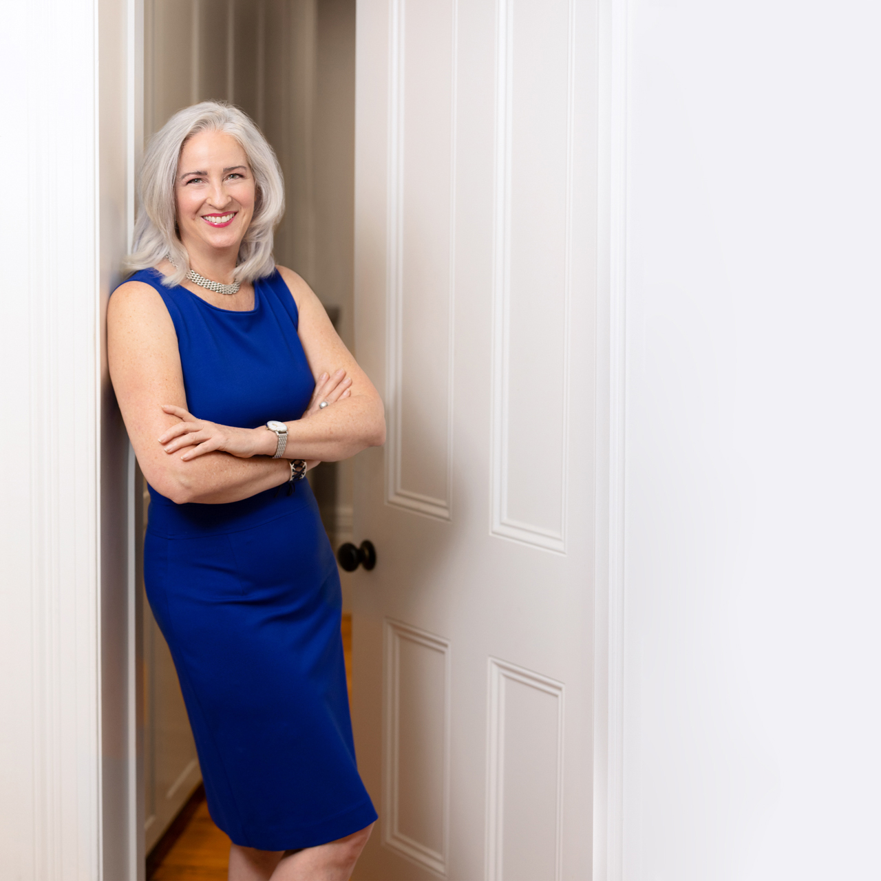 Business woman standing in a doorway