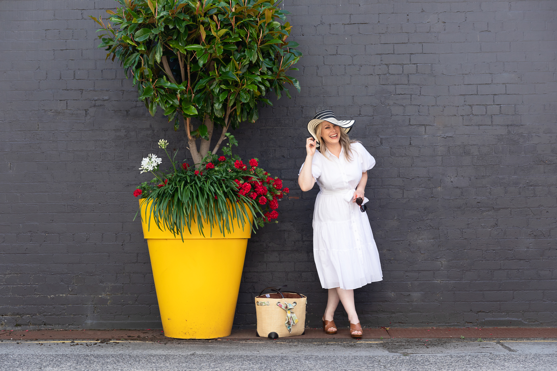personal branding photo of a presentation coach wearing a white dress and sunhat