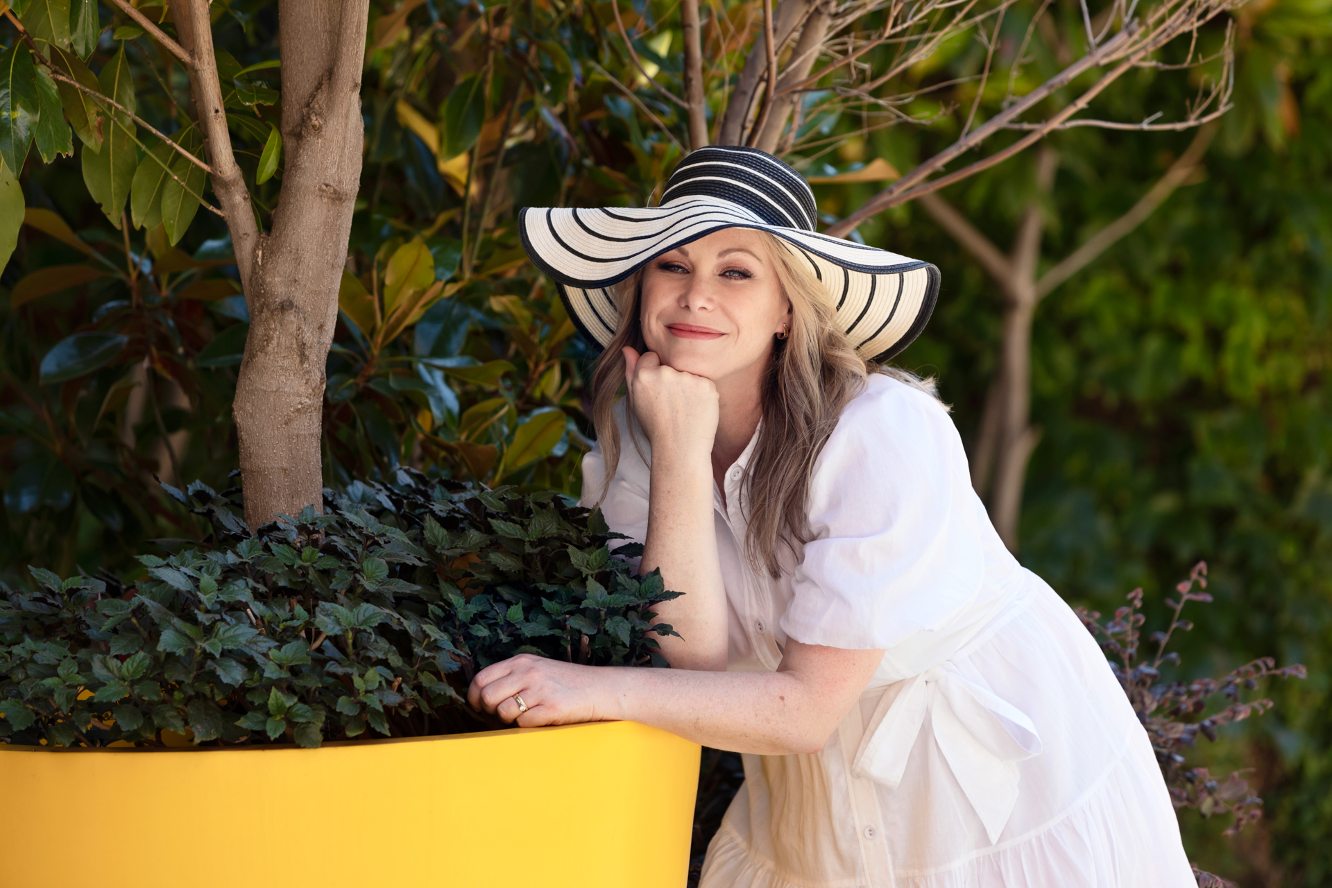 Personal branding photo of a female business owner in a sunhat