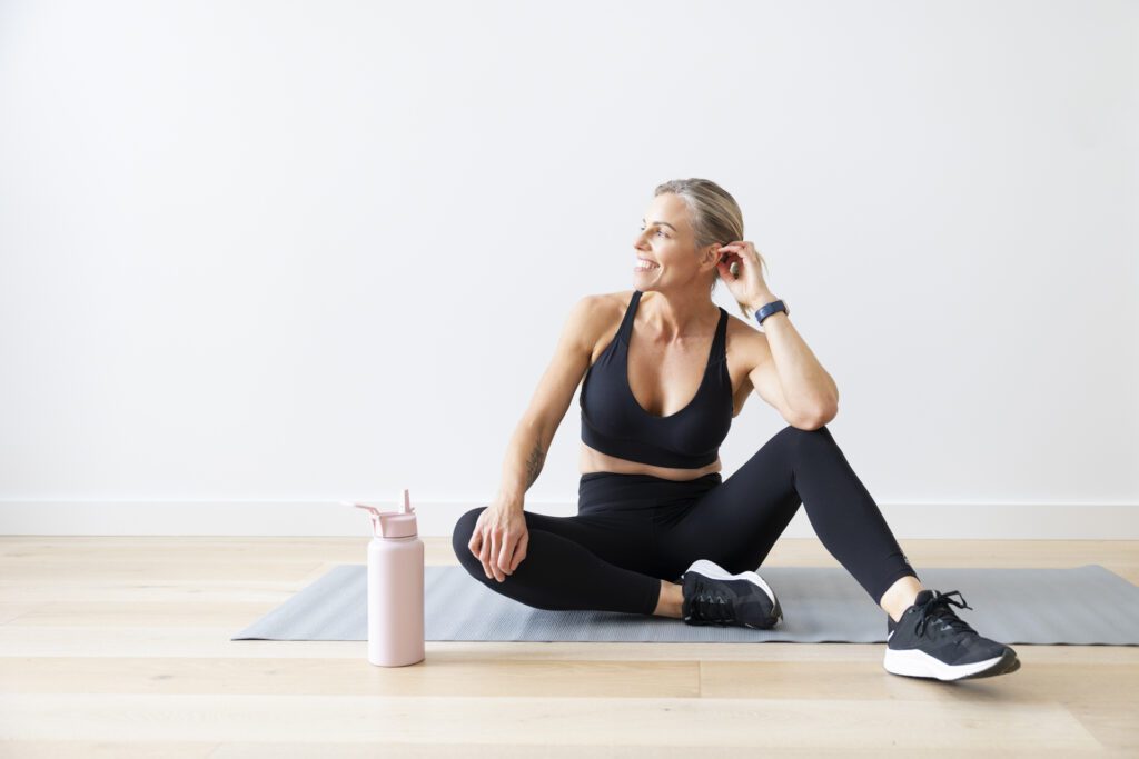 Lady sitting on an exercise mat