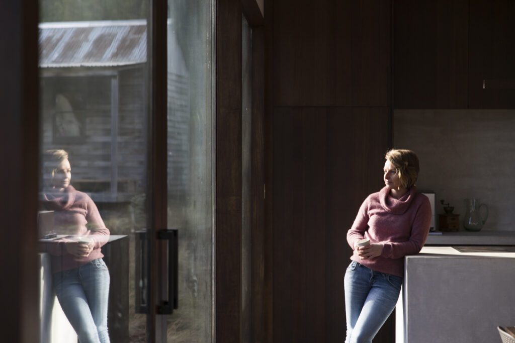 Image of a lady leaning agains a kitchen bench