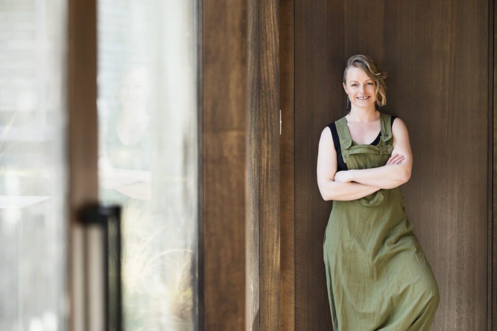 Image of a lady leaning agains a wall