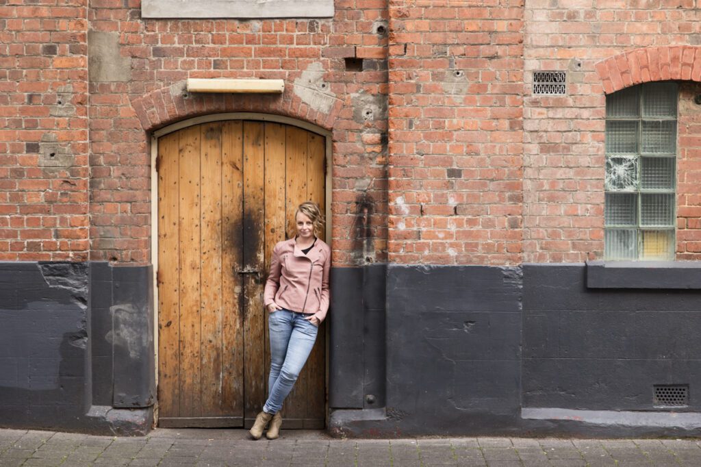 Lady leaning in the doorway of a historic building