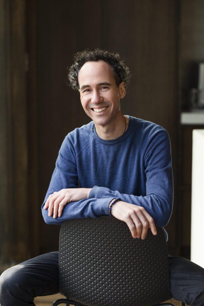 Portrait of a man sitting backwards on a chair