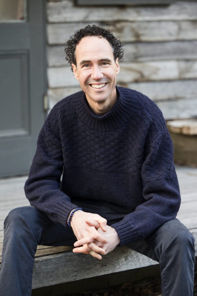 Portrait of a man sitting down on a verandah