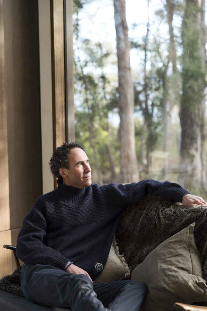 A man sitting on a couch looking out the window