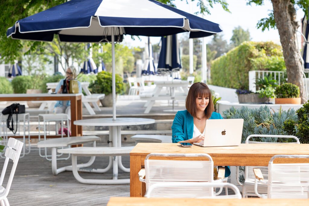 Lady setting in a cafe using her laptop