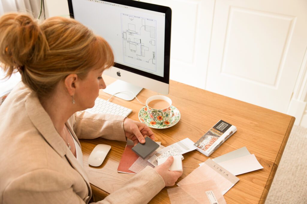 Personal Branding photo of an interior designer in her office looking at samples on her desk