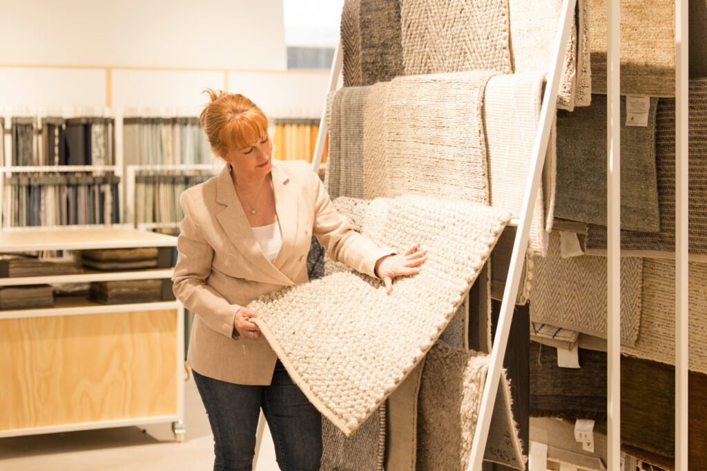 Personal Branding Photo of a female Interior designer looking at fabric samples in a display store