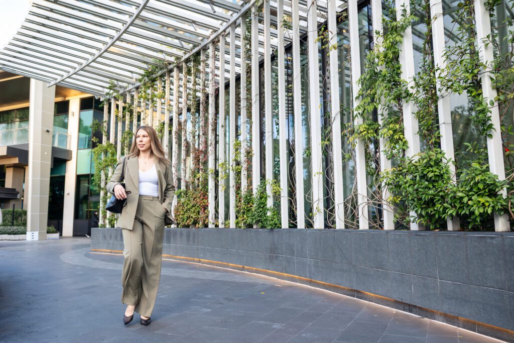 A female business owner khaki pant suit and walking